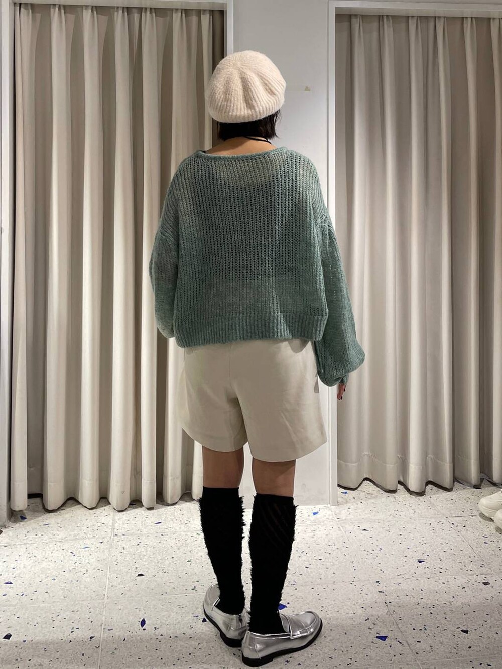 ホワイト系のその他パンツ、シルバー系のローファー、グリーン系のニット/セーターを着用したレディースの秋コーディネートの3枚目の写真