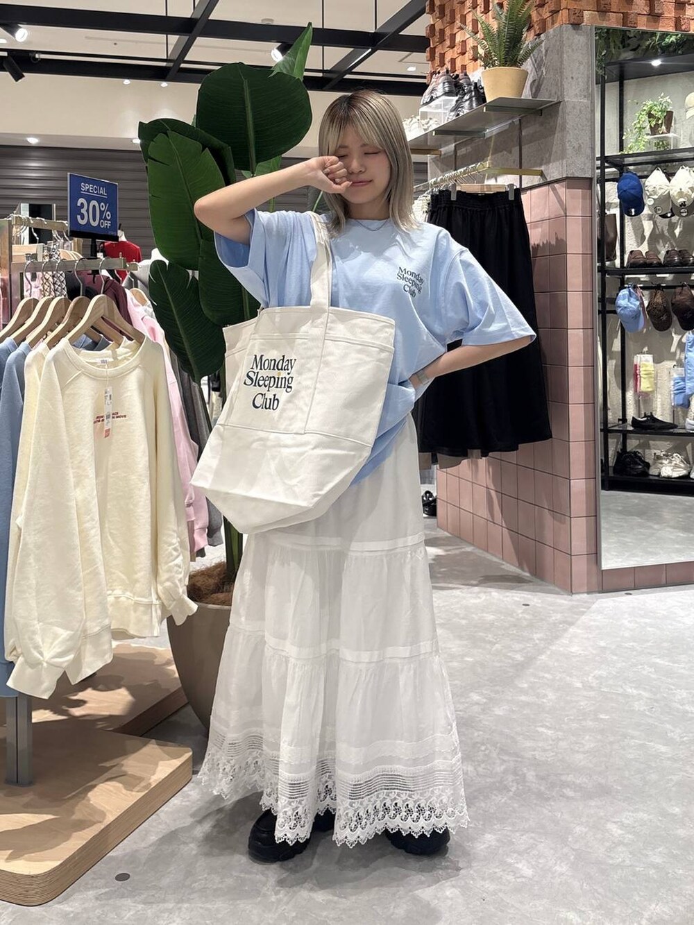 ブラック系のローファー、ブルー系のTシャツ/カットソー、ホワイト系のスカートを着用したレディースの春コーディネートの5枚目の写真