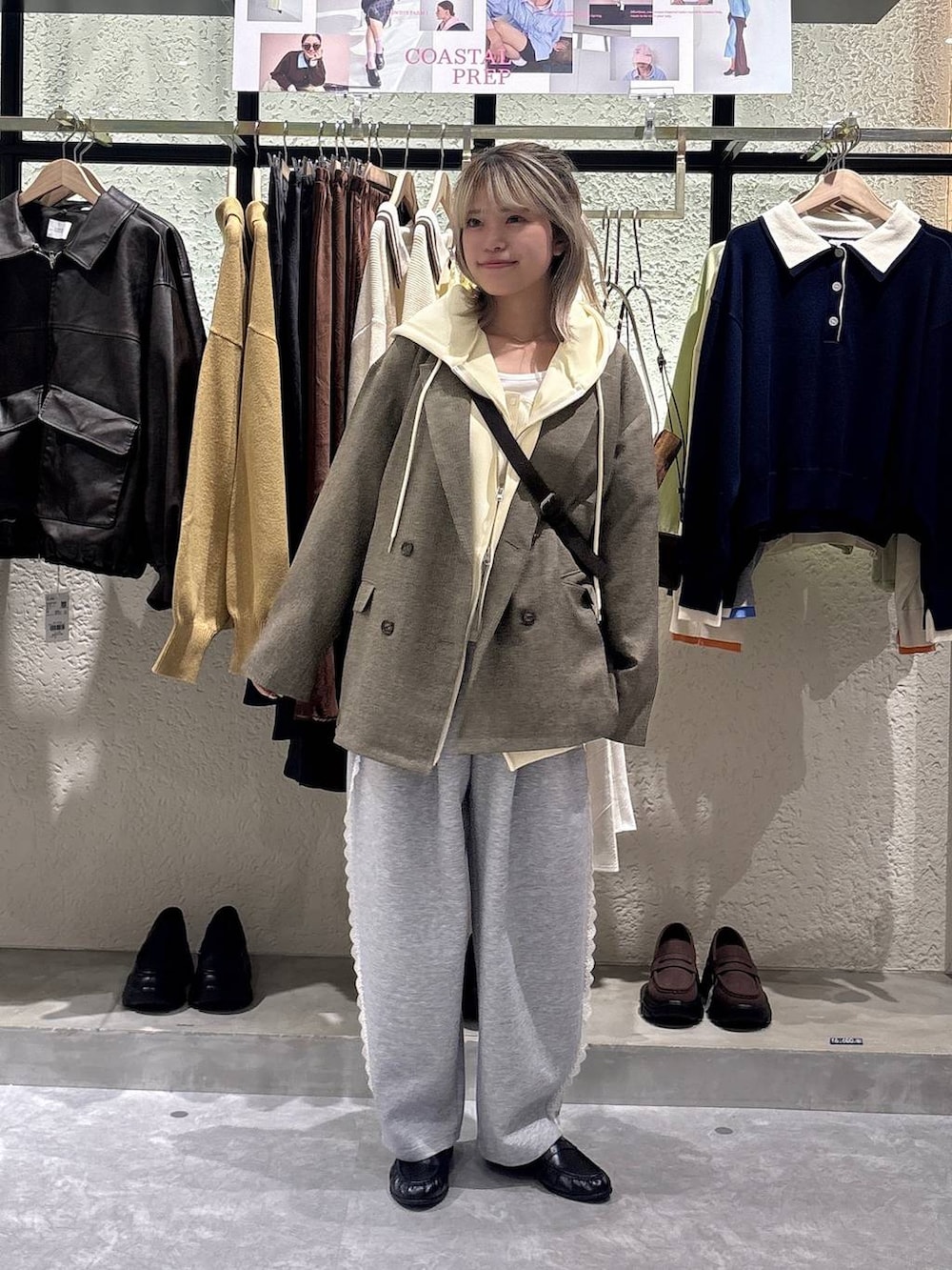 グレー系のスウェットパンツ、イエロー系のパーカー、ブラウン系のテーラードジャケットを着用したレディースの春コーディネートの6枚目の写真