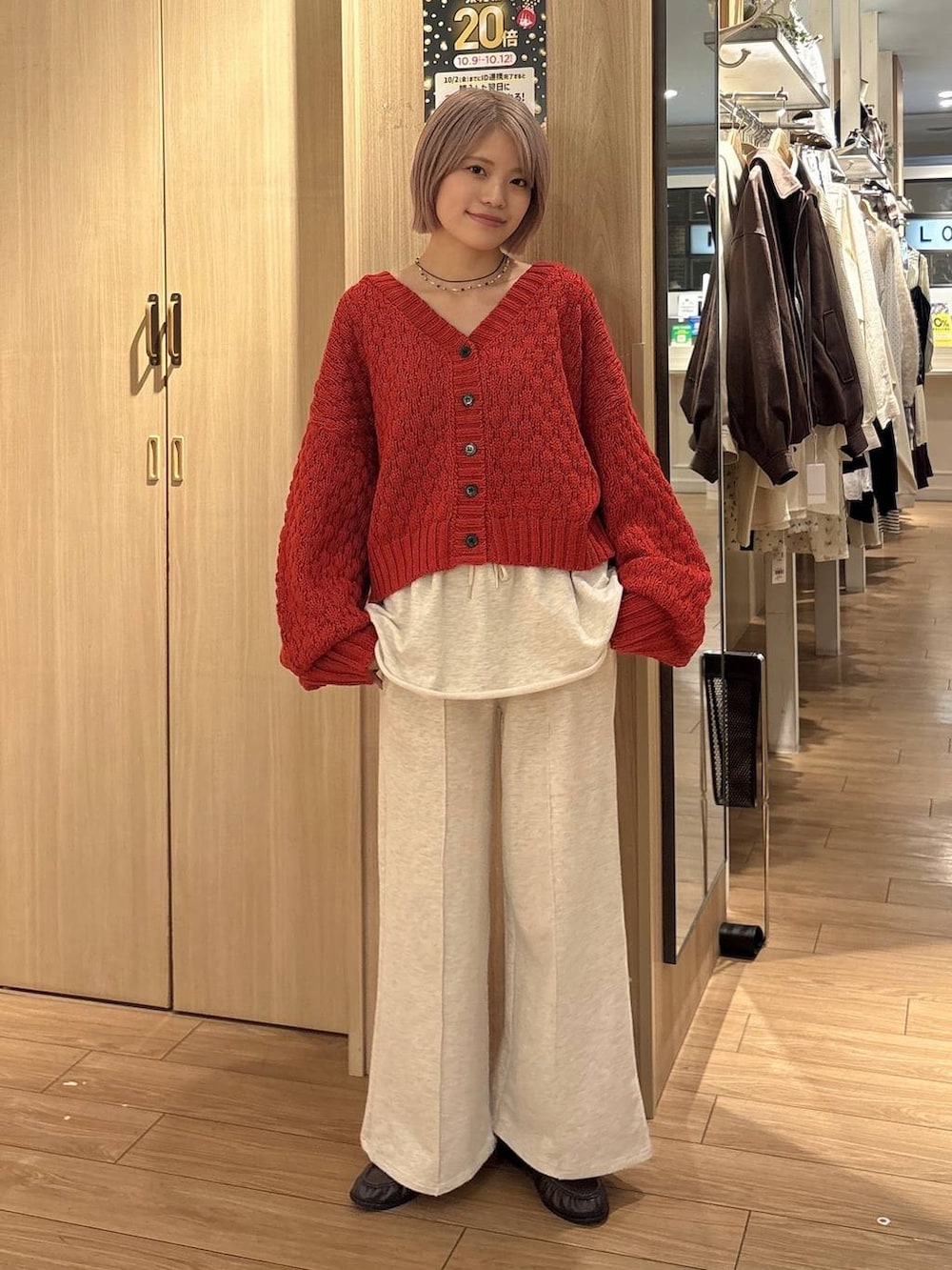 ホワイト系のスウェットパンツ、ブラウン系のローファー、レッド系のカーディガン/ボレロを着用したレディースの秋コーディネートの5枚目の写真