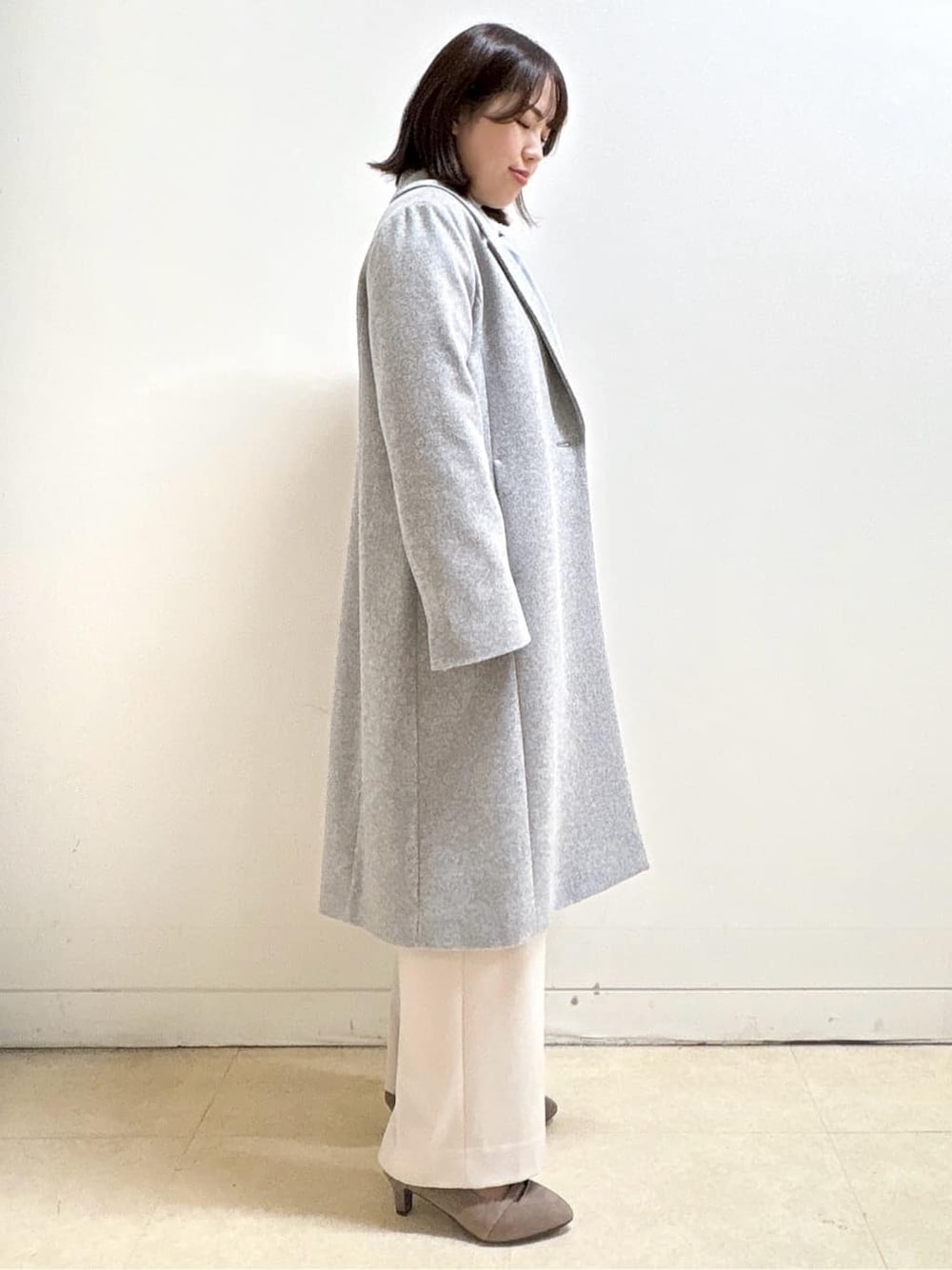 ブルー系のニット/セーター、ブルー系のシャツ/ブラウス、ベージュ系のその他パンツを着用したレディースの冬コーディネートの9枚目の写真