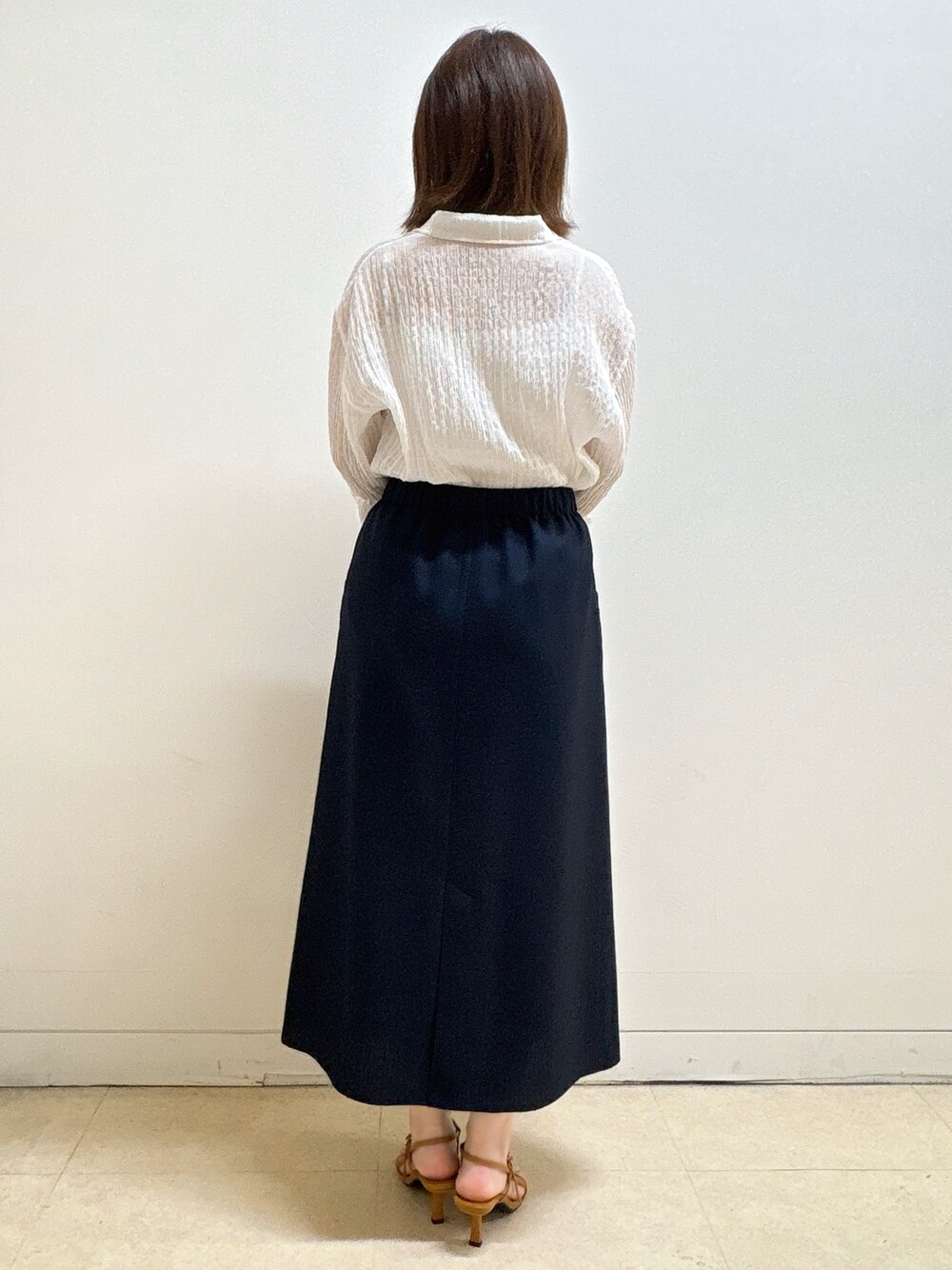 ホワイト系のシャツ/ブラウス、ブルー系のスカート、ベージュ系のトートバッグを着用したレディースの夏コーディネートの6枚目の写真