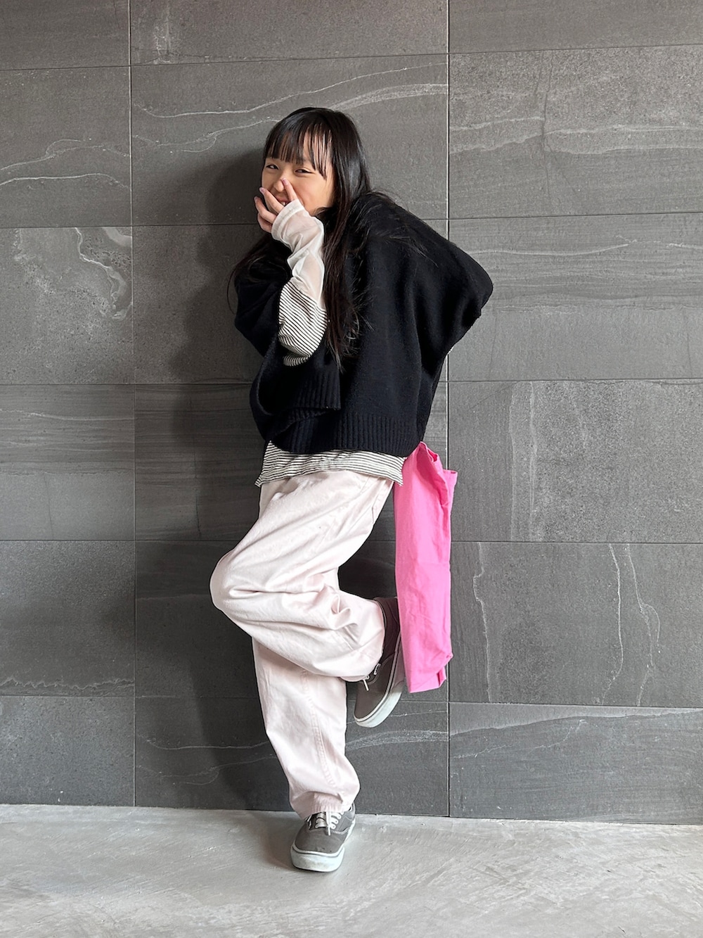 ブラック系のベスト、ホワイト系のTシャツ/カットソー、ピンク系のデニムパンツを着用したキッズの冬コーディネートの3枚目の写真