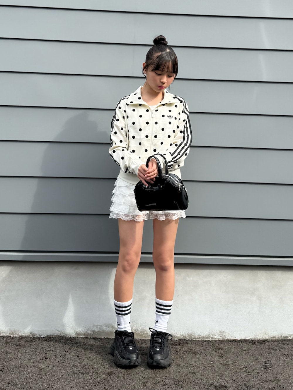 ホワイト系のその他アウター、ホワイト系のその他パンツ、ブラック系のショルダーバッグを着用したキッズの春コーディネートの4枚目の写真