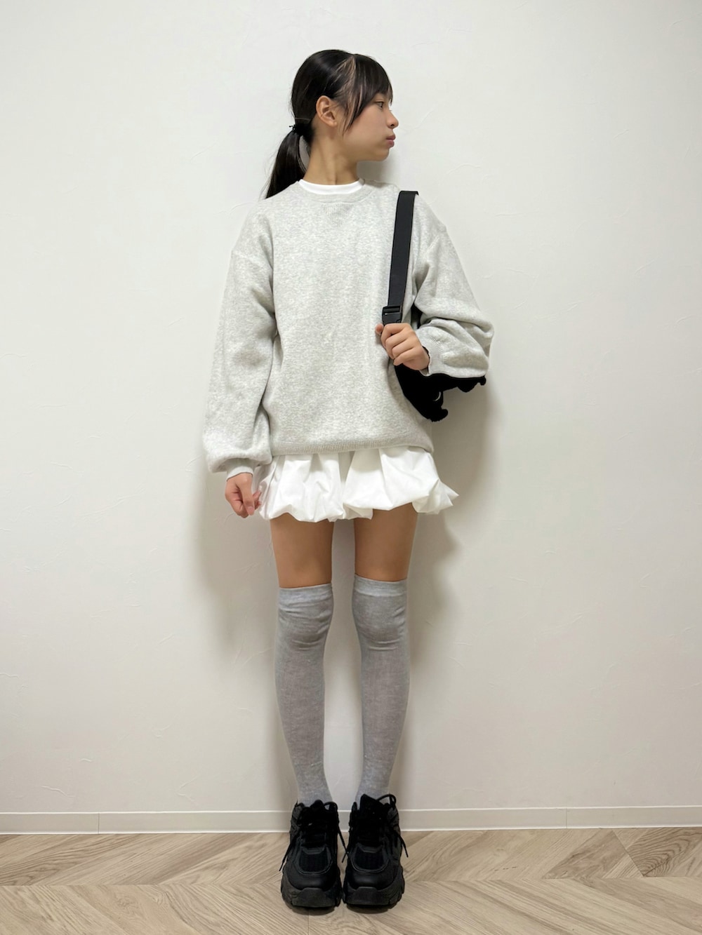 ホワイト系のニット/セーター、ホワイト系のニット/セーター、ブラック系のショルダーバッグを着用したキッズの秋コーディネートの2枚目の写真