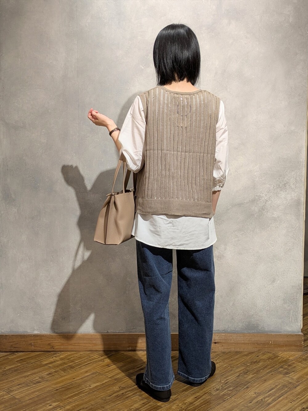 ブルー系のデニムパンツ、ブラウン系のその他シューズ、ベージュ系のトートバッグを着用したレディースの夏コーディネートの4枚目の写真