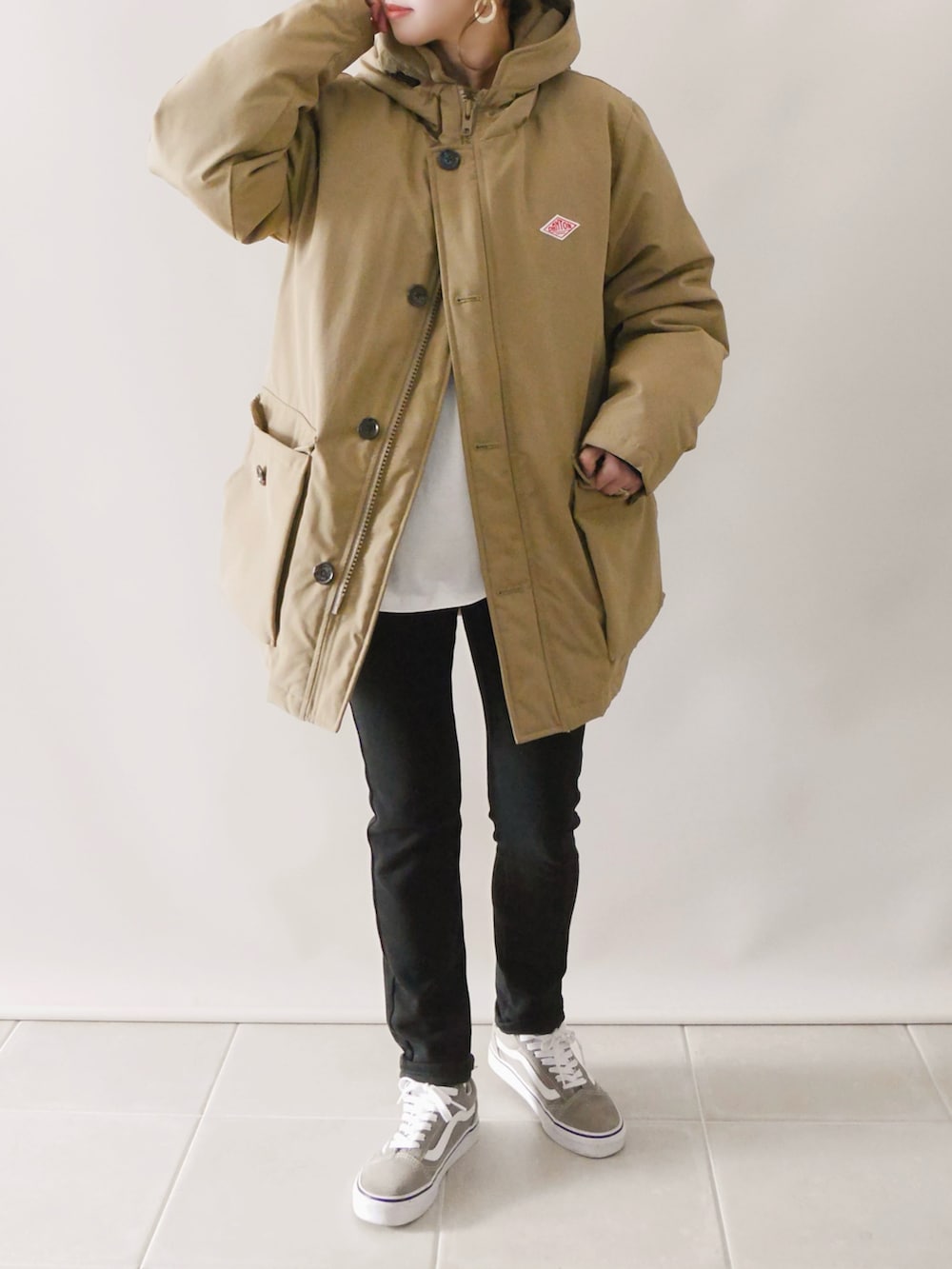 ベージュ系のダウンジャケット/コート、ブラック系のパンツ、ベージュ系のスニーカーを着用したレディースの冬コーディネートの2枚目の写真