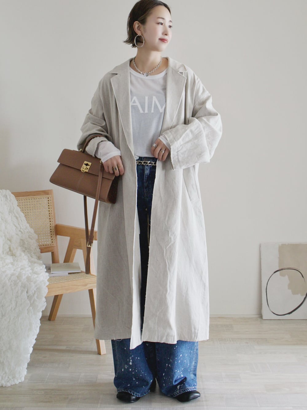 ホワイト系のTシャツ/カットソー、ベージュ系のその他アウター、ブルー系のデニムパンツを着用したレディースの冬コーディネートの2枚目の写真