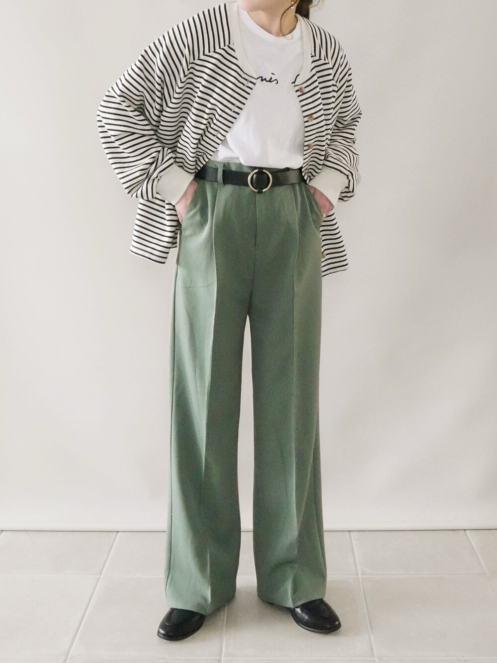 ホワイト系のトップス、グリーン系のパンツ、ベージュ系のショルダーバッグを着用したレディースの冬コーディネートの2枚目の写真