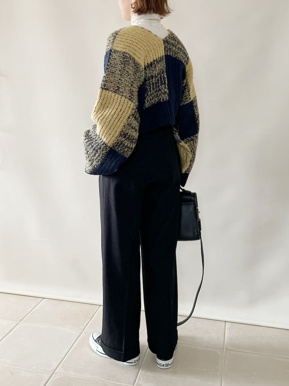 ブルー系のカーディガン/ボレロ、ブラック系のパンツ、ブラック系のバッグを着用したレディースの秋コーディネートの3枚目の写真