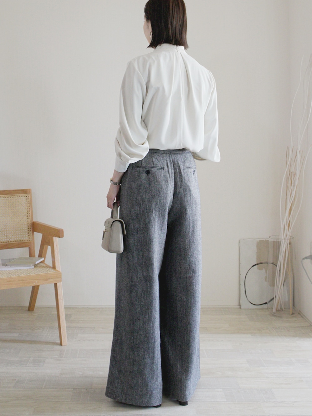 ホワイト系のシャツ/ブラウス、グレー系のパンツ、ベージュ系のバッグを着用したレディースの秋コーディネートの2枚目の写真