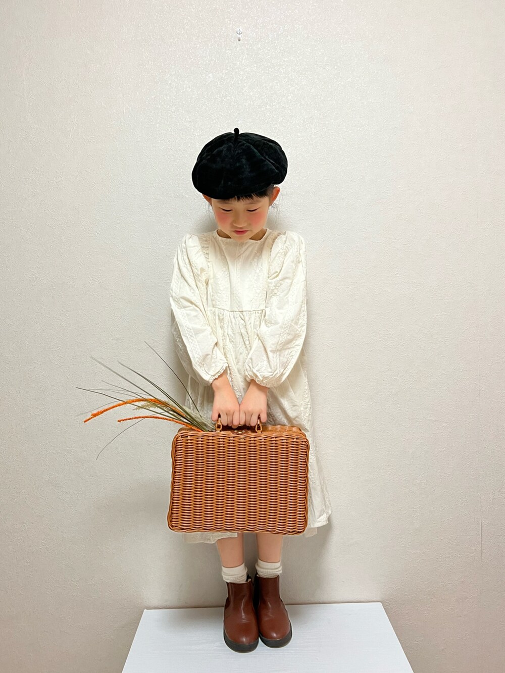 ホワイト系のワンピース/ドレス、ブラウン系のバッグ、ブラウン系のブーツを着用したキッズの秋コーディネートの2枚目の写真