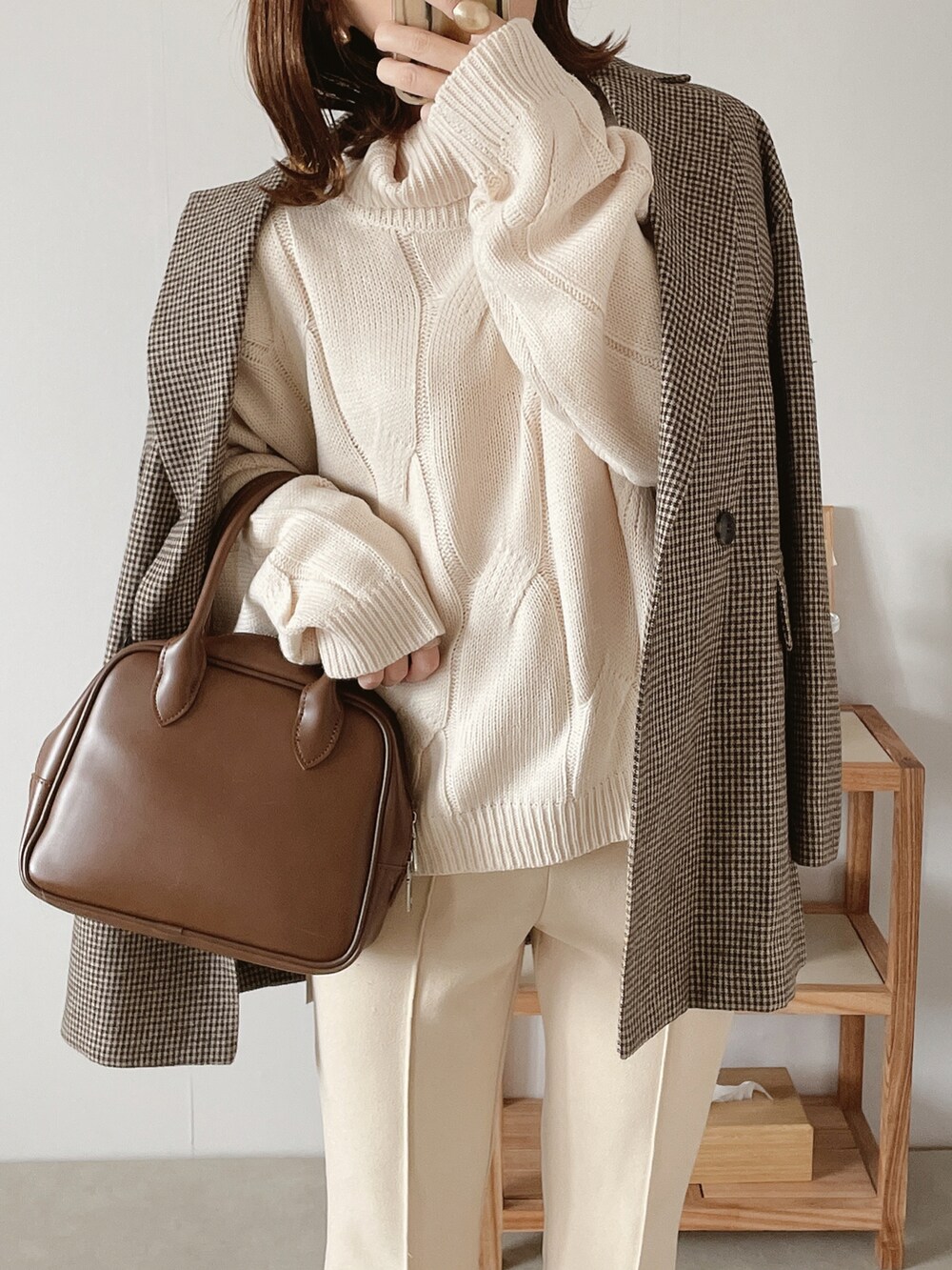 ブラウン系のテーラードジャケット、ブラウン系のボストンバッグ、ホワイト系のその他パンツを着用したレディースの秋コーディネートの3枚目の写真