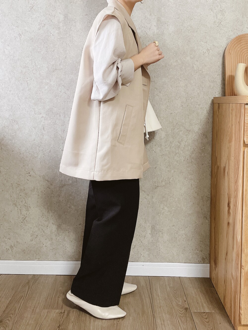 ブラック系のその他パンツ、ホワイト系のシューズ、ホワイト系のバッグを着用したレディースの春コーディネートの2枚目の写真