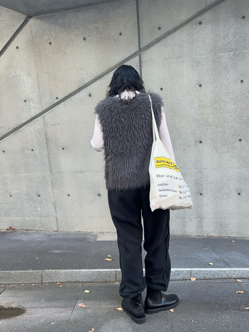 ブラック系のその他パンツ、ホワイト系のTシャツ/カットソー、グレー系のベストを着用したレディースの秋コーディネートの4枚目の写真
