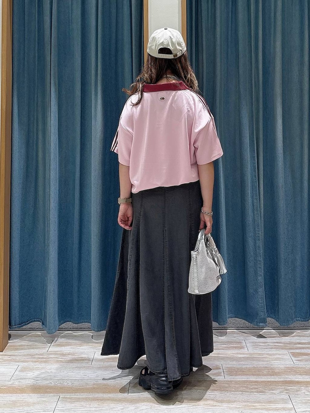 グレー系のショルダーバッグ、ブラック系のスカート、ピンク系のTシャツ/カットソーを着用したレディースの夏コーディネートの3枚目の写真