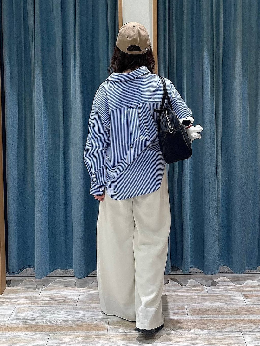 ブラック系のボストンバッグ、ベージュ系のその他パンツ、ブラック系のスニーカーを着用したレディースの冬コーディネートの3枚目の写真