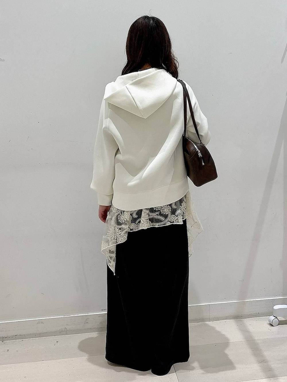 シルバー系のバレエシューズ、ホワイト系のパーカー、ホワイト系のその他トップスを着用したレディースの冬コーディネートの3枚目の写真