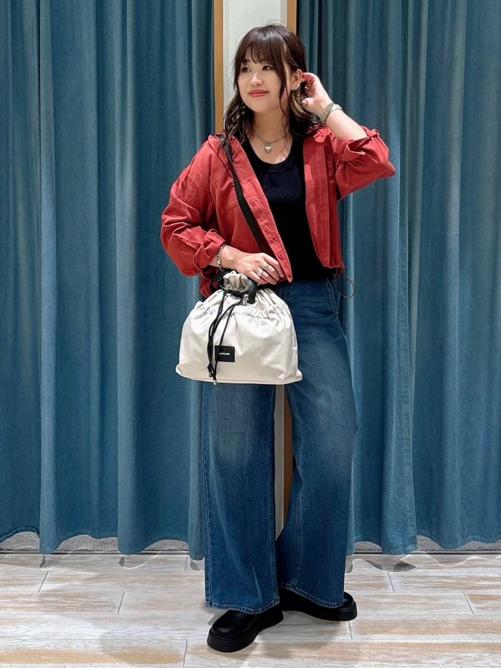 ホワイト系のトートバッグ、ブラック系のサンダル、ブラック系のニット/セーターを着用したレディースの秋コーディネートの4枚目の写真