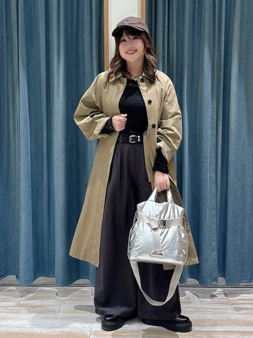 シルバー系のトートバッグ、ブラック系のブーツ、ブラック系のTシャツ/カットソーを着用したレディースの冬コーディネートの4枚目の写真