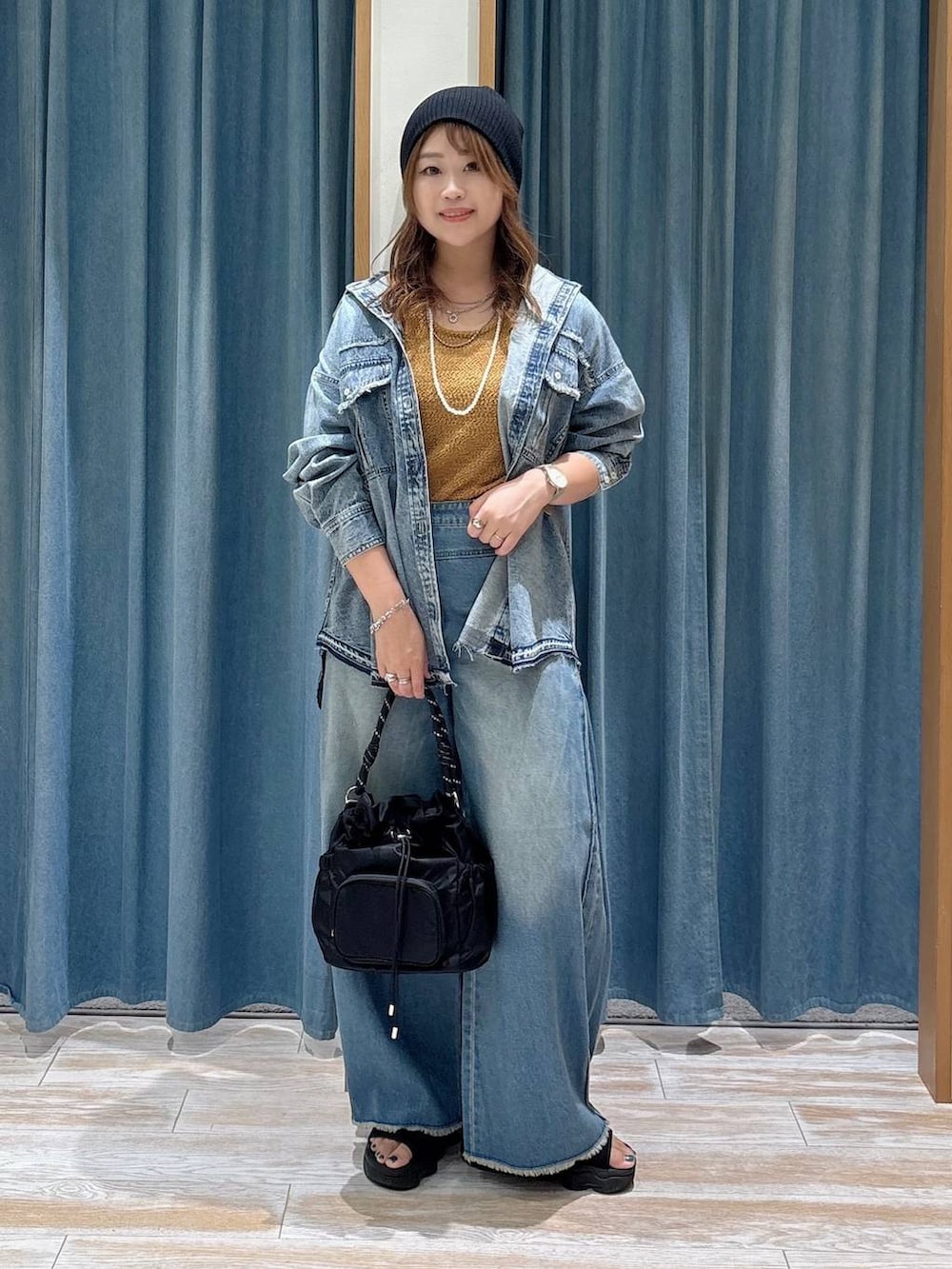 イエロー系のニット/セーター、ブルー系のデニムパンツ、ブルー系のシャツ/ブラウスを着用したレディースの秋コーディネートの4枚目の写真