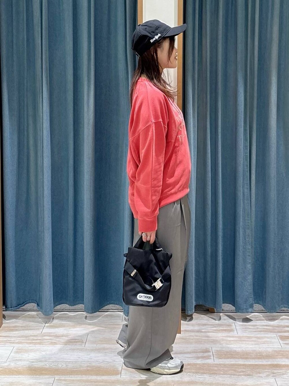 グレー系のその他パンツ、レッド系のスウェット、ブラック系のショルダーバッグを着用したレディースの秋コーディネートの2枚目の写真