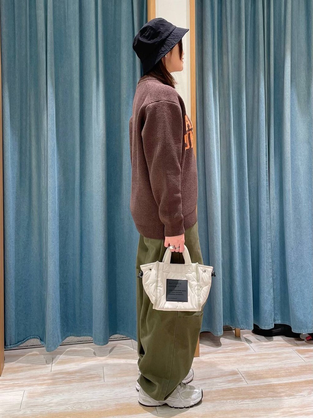 ホワイト系のショルダーバッグ、グリーン系のその他パンツ、ブラウン系のニット/セーターを着用したレディースの冬コーディネートの2枚目の写真