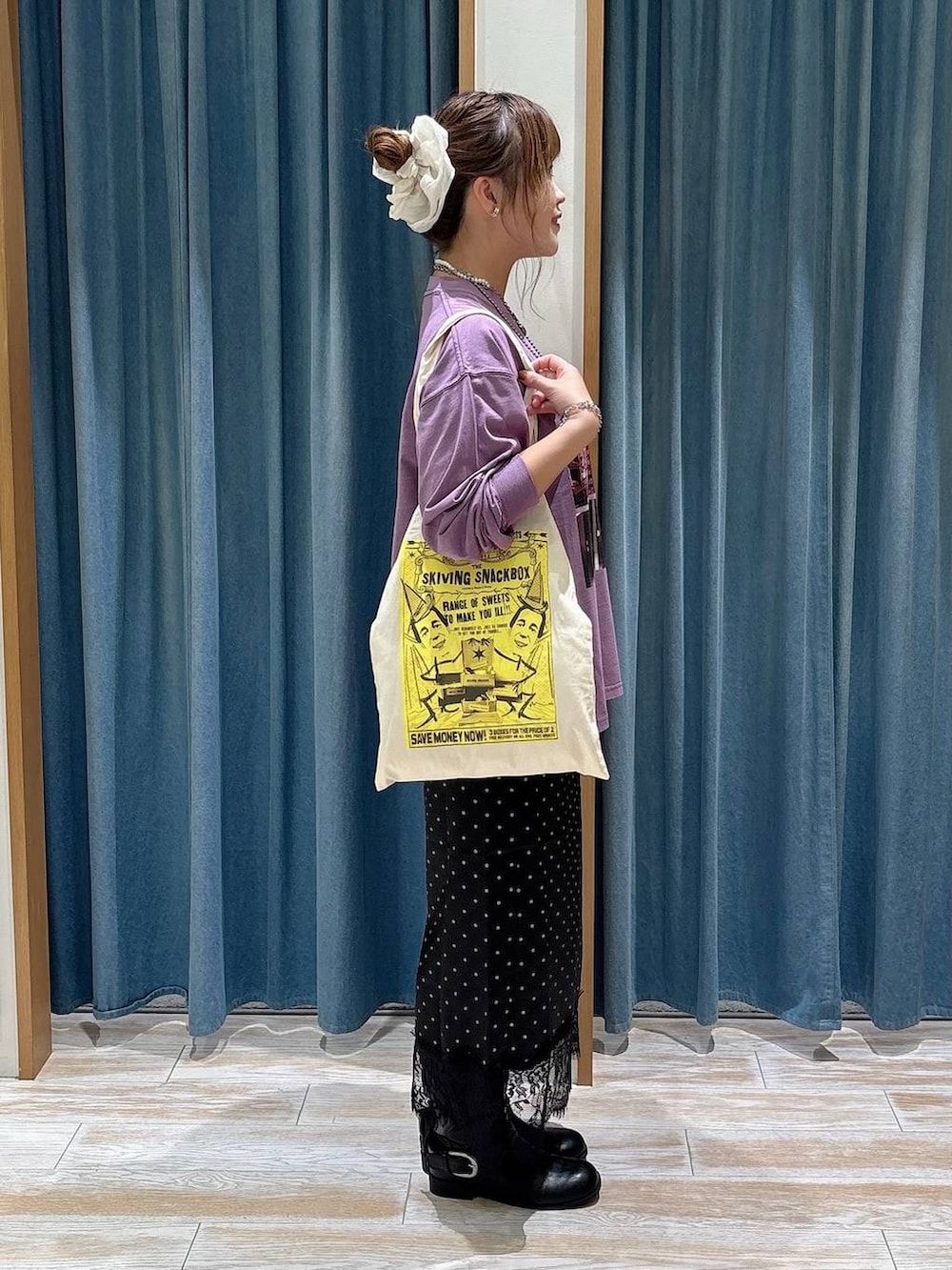 ブラック系のスカート、ブラック系のブーツ、パープル系のTシャツ/カットソーを着用したレディースの秋コーディネートの2枚目の写真