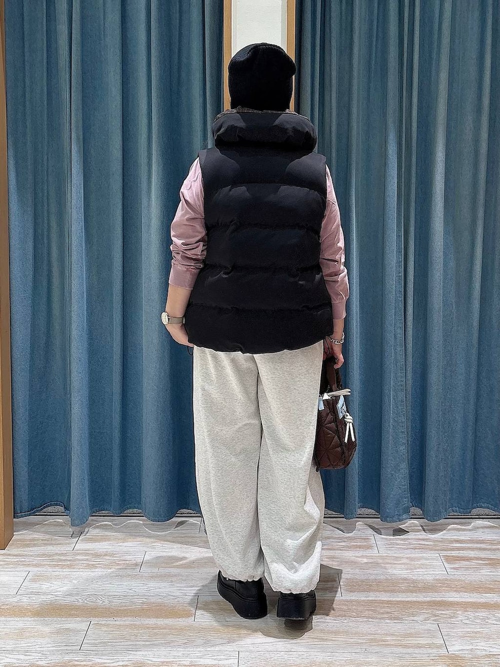 ベージュ系のスウェットパンツ、ブラック系のその他アウター、ブラウン系のショルダーバッグを着用したレディースの秋コーディネートの3枚目の写真