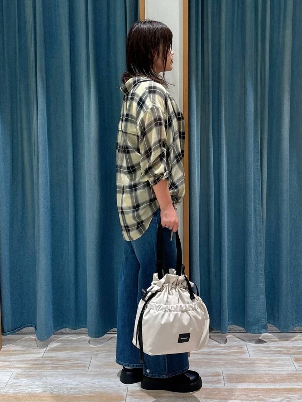 ブラック系のキャミソール、ホワイト系のトートバッグ、ブラック系のサンダルを着用したレディースの秋コーディネートの2枚目の写真