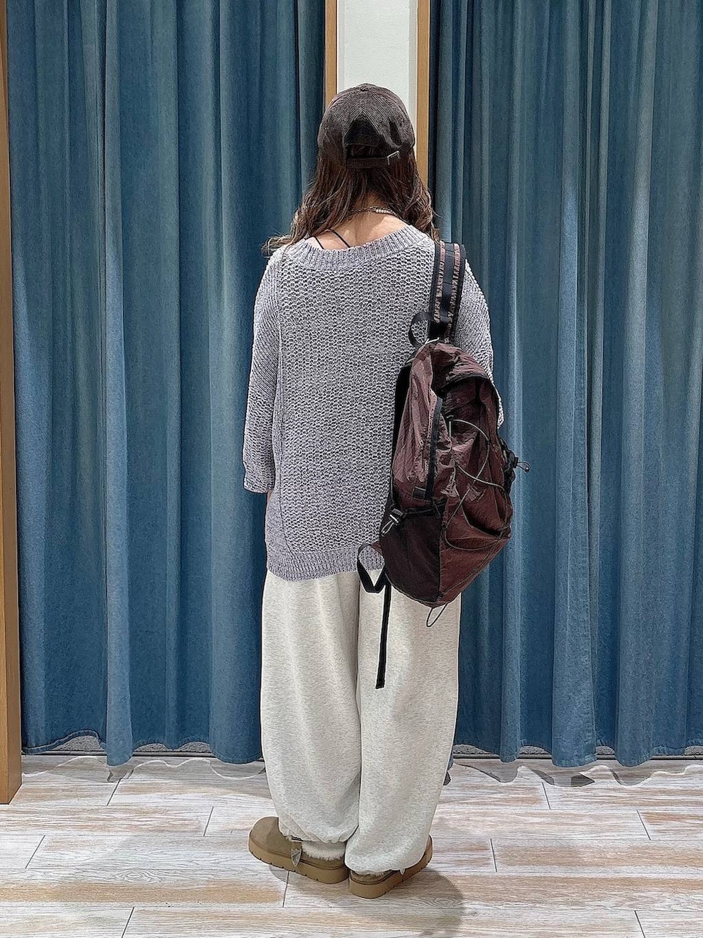 ベージュ系のスウェットパンツ、ブラウン系のバックパック/リュック、パープル系のカーディガン/ボレロを着用したレディースの秋コーディネートの3枚目の写真