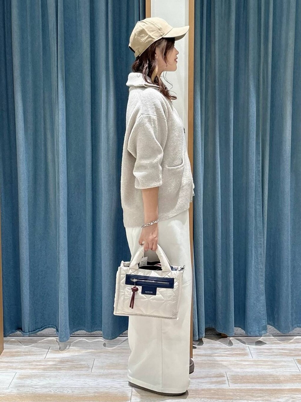 ホワイト系のショルダーバッグ、ベージュ系のその他パンツ、ベージュ系のブーツを着用したレディースの秋コーディネートの2枚目の写真