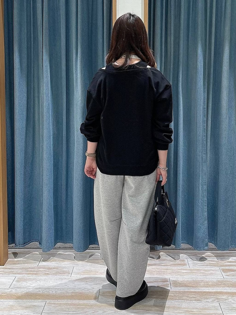 ブラック系のブーツ、ブラック系のトートバッグ、グレー系のその他パンツを着用したレディースの冬コーディネートの3枚目の写真