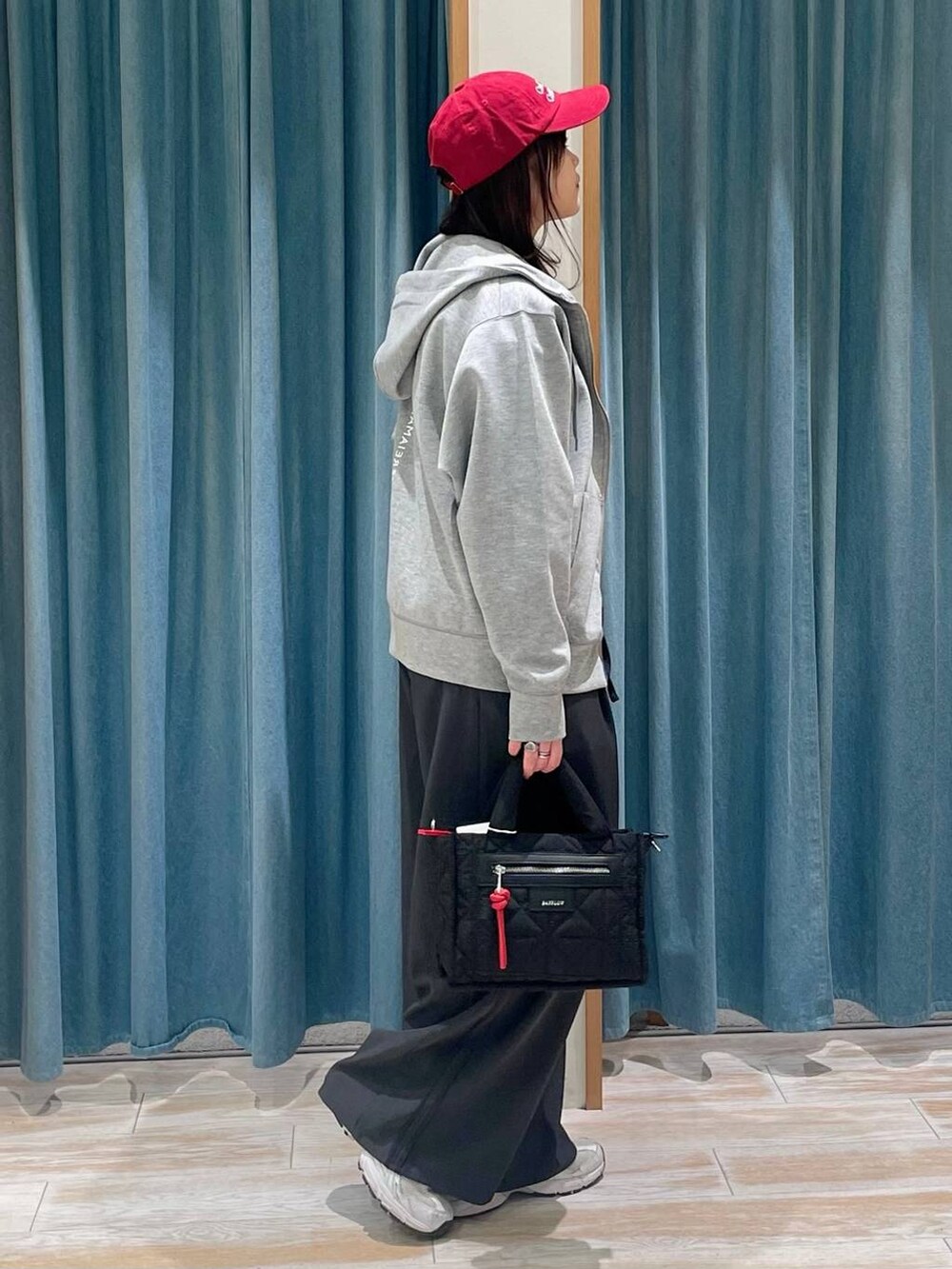 グレー系のその他パンツ、グレー系のパーカー、ブラック系のショルダーバッグを着用したレディースの春コーディネートの2枚目の写真