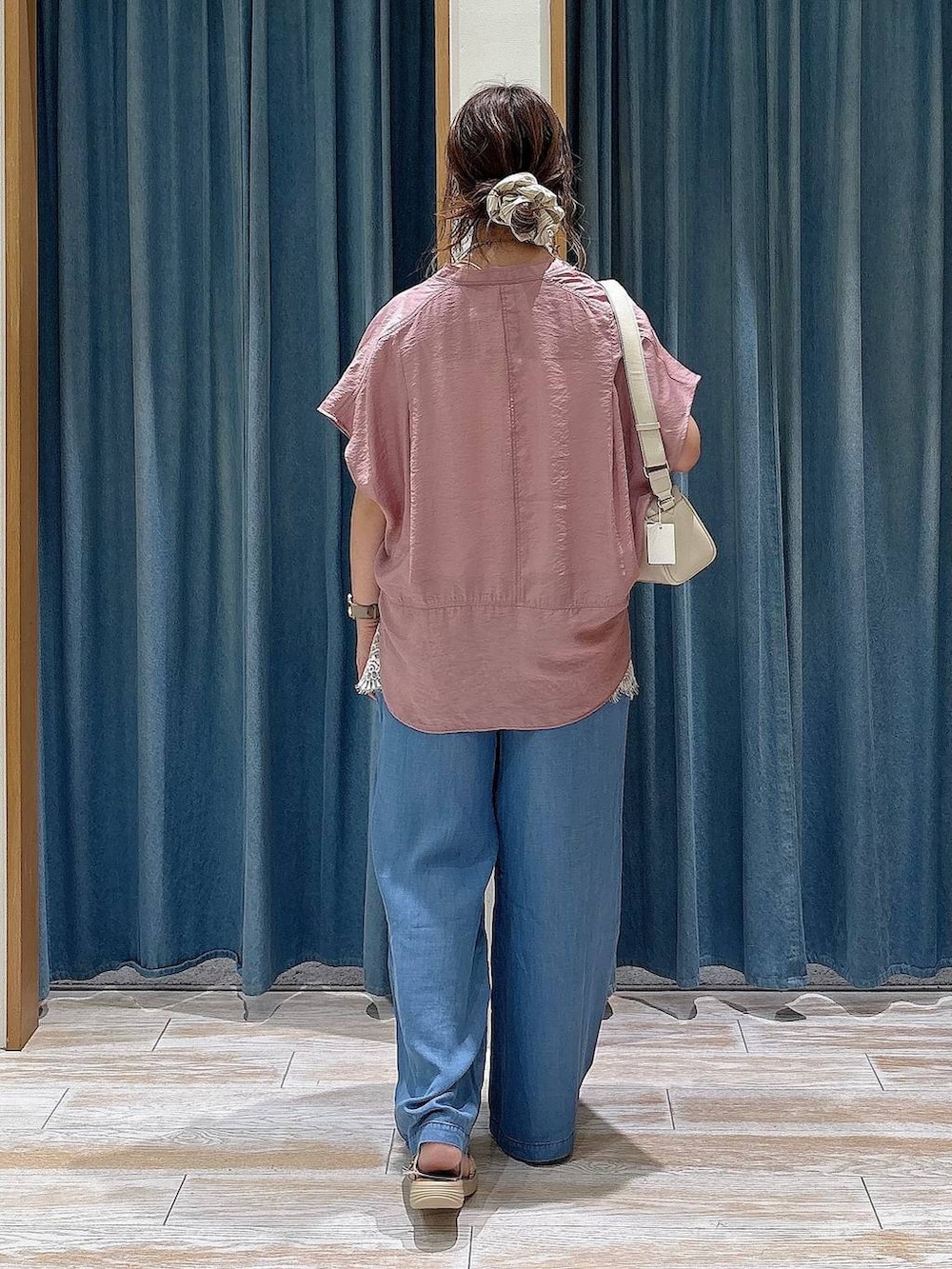 ブルー系のデニムパンツ、ピンク系のシャツ/ブラウス、シルバー系のサンダルを着用したレディースの夏コーディネートの3枚目の写真