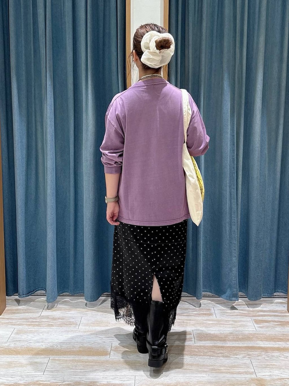 ブラック系のスカート、ブラック系のブーツ、パープル系のTシャツ/カットソーを着用したレディースの秋コーディネートの3枚目の写真