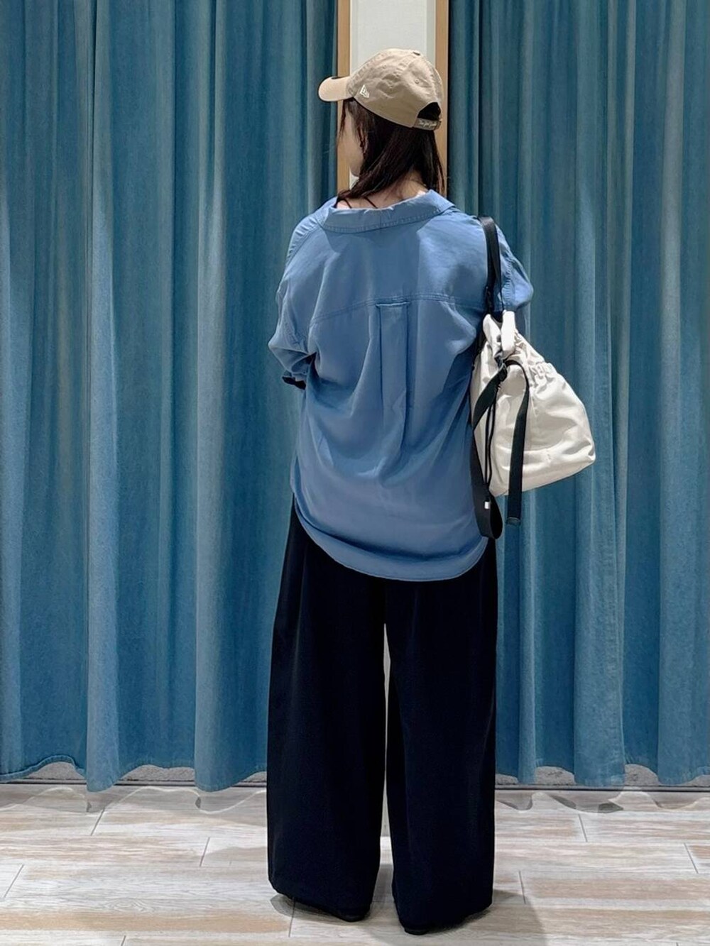 ブラック系のキャミソール、ホワイト系のトートバッグ、ブラック系のその他パンツを着用したレディースの秋コーディネートの3枚目の写真