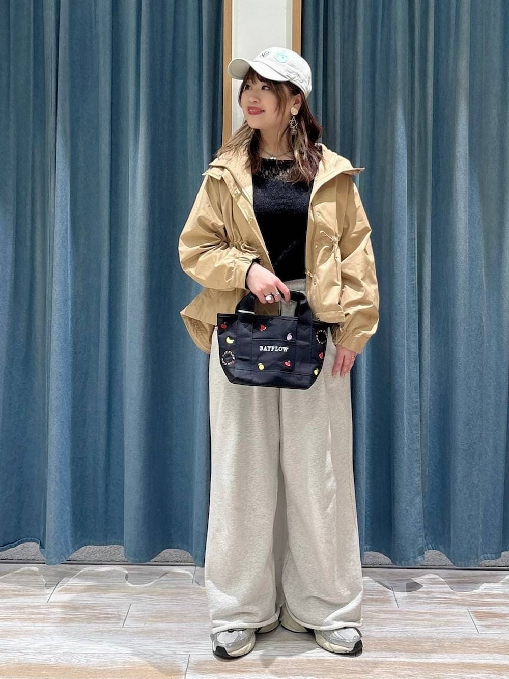 ブラック系のTシャツ/カットソー、イエロー系のマウンテンパーカー、ホワイト系のスウェットパンツを着用したレディースの春コーディネートの4枚目の写真