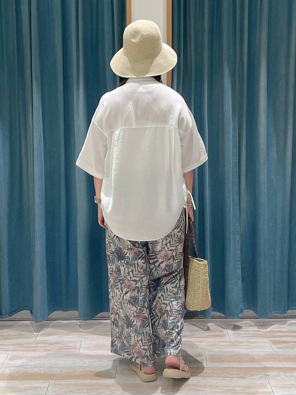 ベージュ系のトートバッグ、グリーン系のその他パンツ、ゴールド系のサンダルを着用したレディースの春コーディネートの3枚目の写真