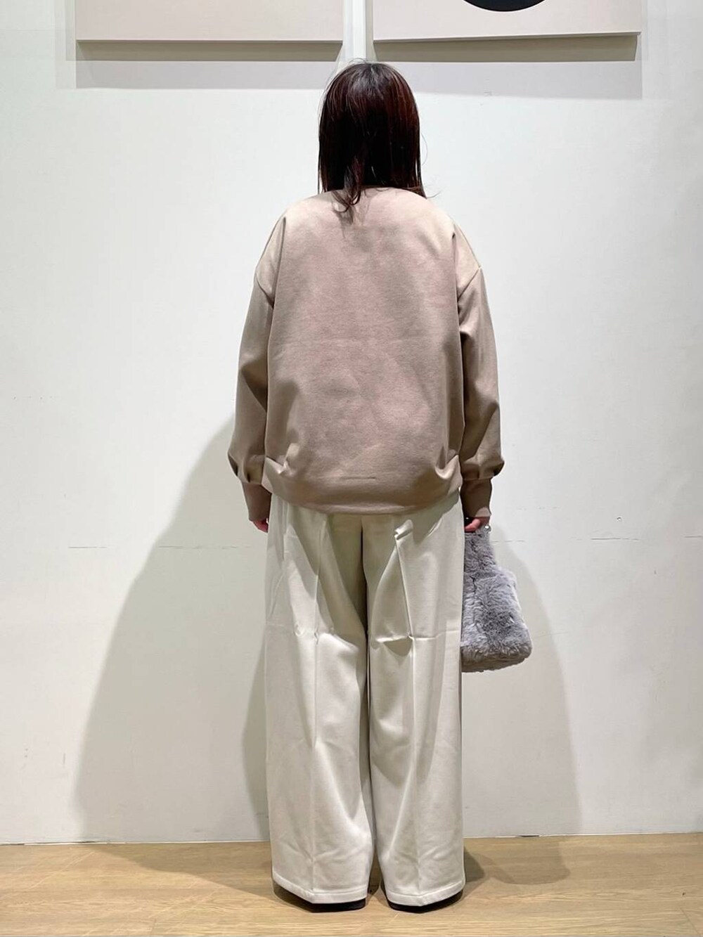 ブラウン系のブルゾン、ホワイト系のTシャツ/カットソー、ホワイト系のベストを着用したレディースの秋コーディネートの3枚目の写真
