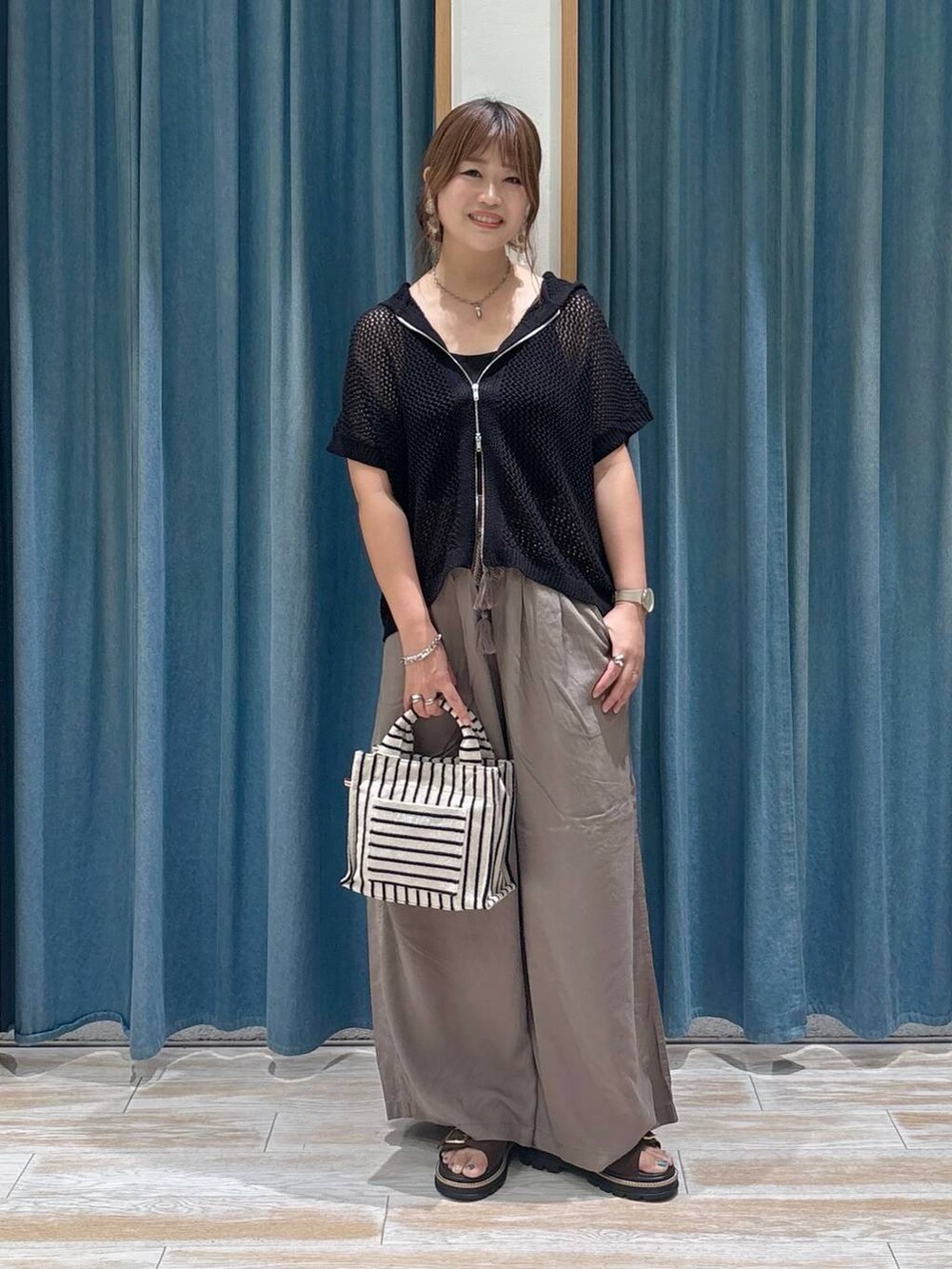 ブラウン系のその他パンツ、ブラウン系のサンダル、ベージュ系のトートバッグを着用したレディースの夏コーディネートの4枚目の写真