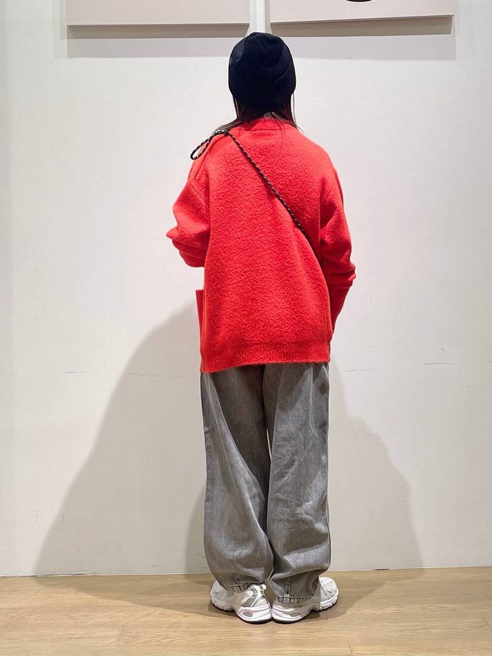 ホワイト系のTシャツ/カットソー、ブラック系のデニムパンツ、オレンジ系のカーディガン/ボレロを着用したレディースの秋コーディネートの2枚目の写真