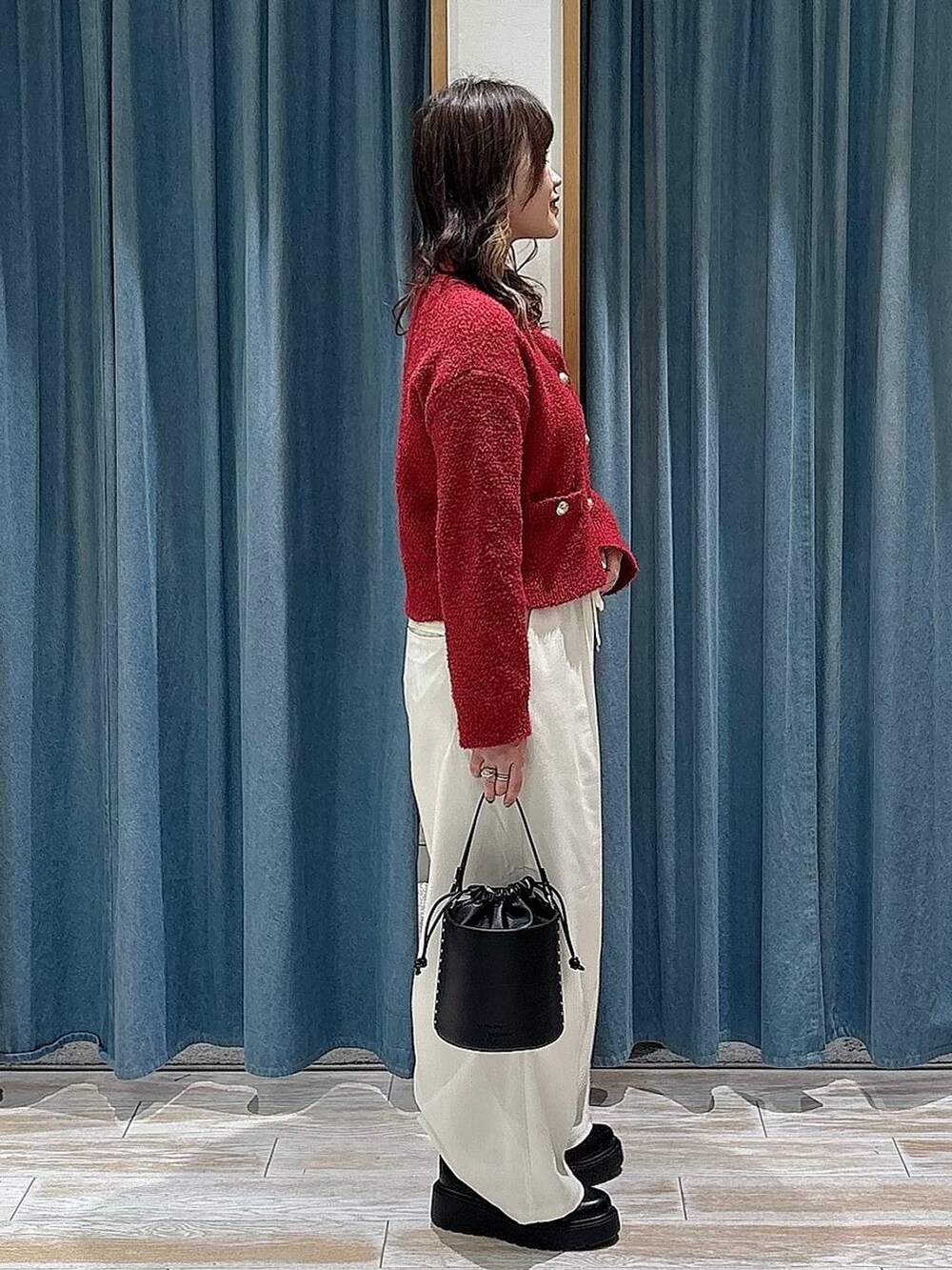 ベージュ系のその他パンツ、ブラック系のブーツ、ブラック系のハンドバッグを着用したレディースの冬コーディネートの2枚目の写真