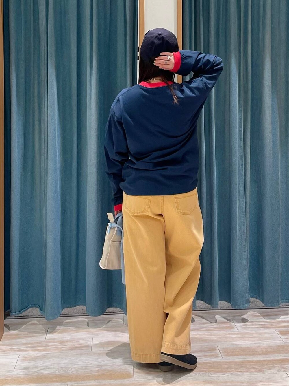 ブラック系のスニーカー、オレンジ系のデニムパンツ、ブルー系のTシャツ/カットソーを着用したレディースの冬コーディネートの3枚目の写真