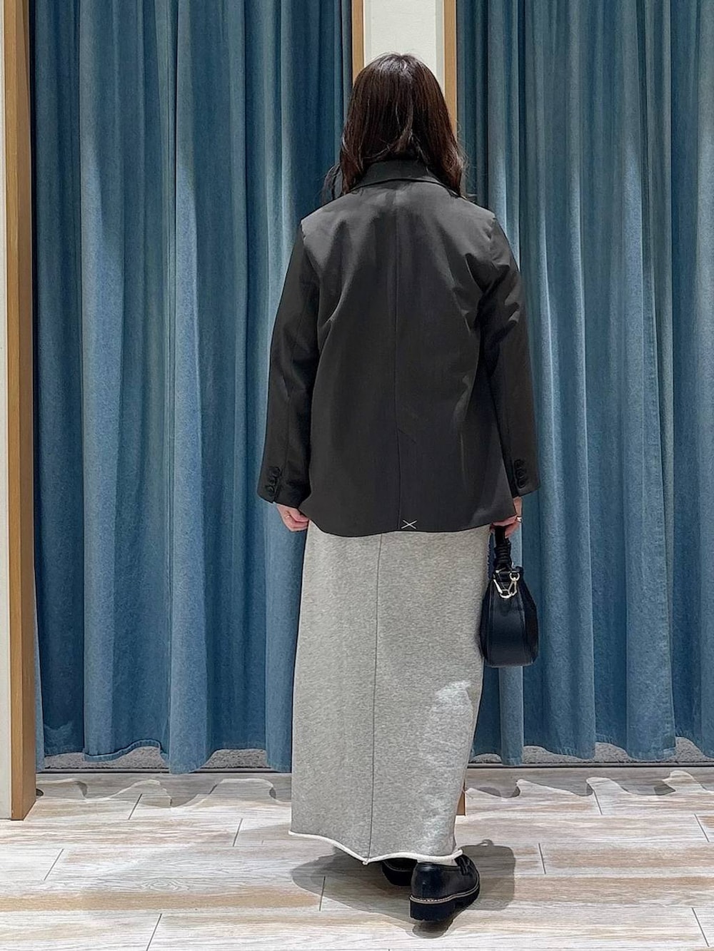 ピンク系のシャツ/ブラウス、ブラック系のハンドバッグ、グレー系のスカートを着用したレディースの春コーディネートの3枚目の写真