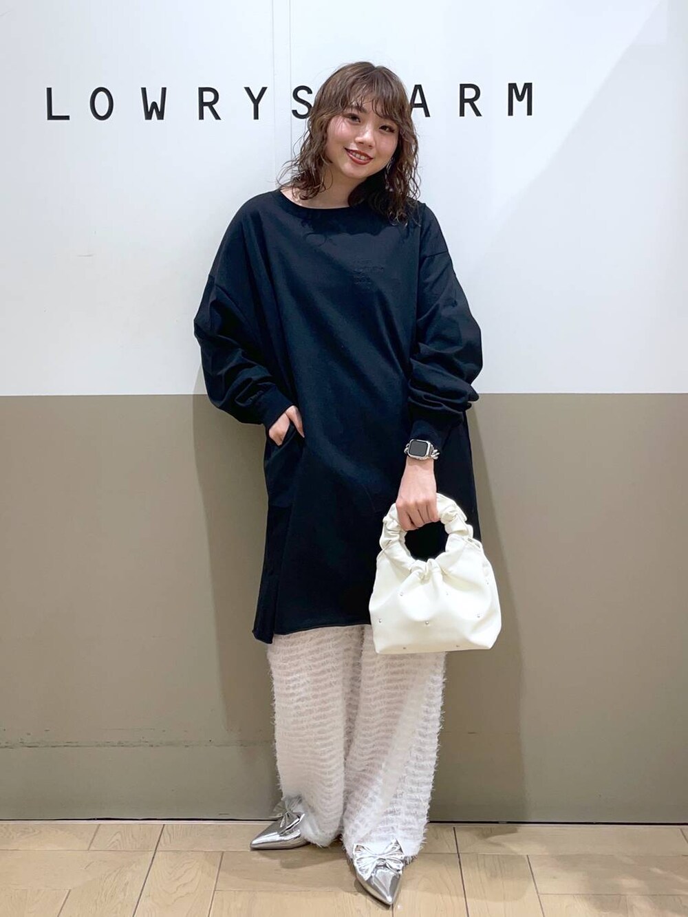 シルバー系のパンプス、ホワイト系のその他パンツ、ベージュ系のハンドバッグを着用したレディースの春コーディネートの2枚目の写真