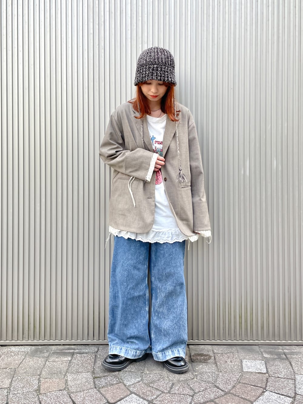 ベージュ系のテーラードジャケット、ブラック系のハットを着用したレディースの秋コーディネートの2枚目の写真