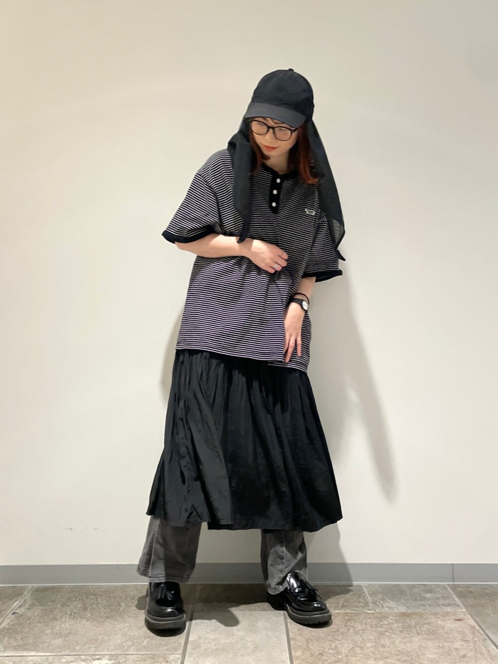 ブラック系のキャップを着用したレディースの春コーディネートの2枚目の写真