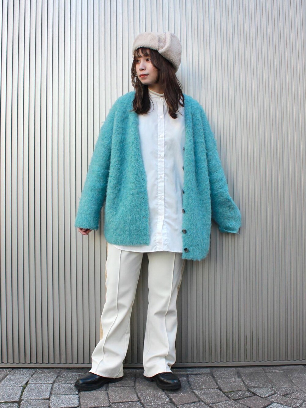 ベージュ系のハットを着用したレディースの冬コーディネートの2枚目の写真