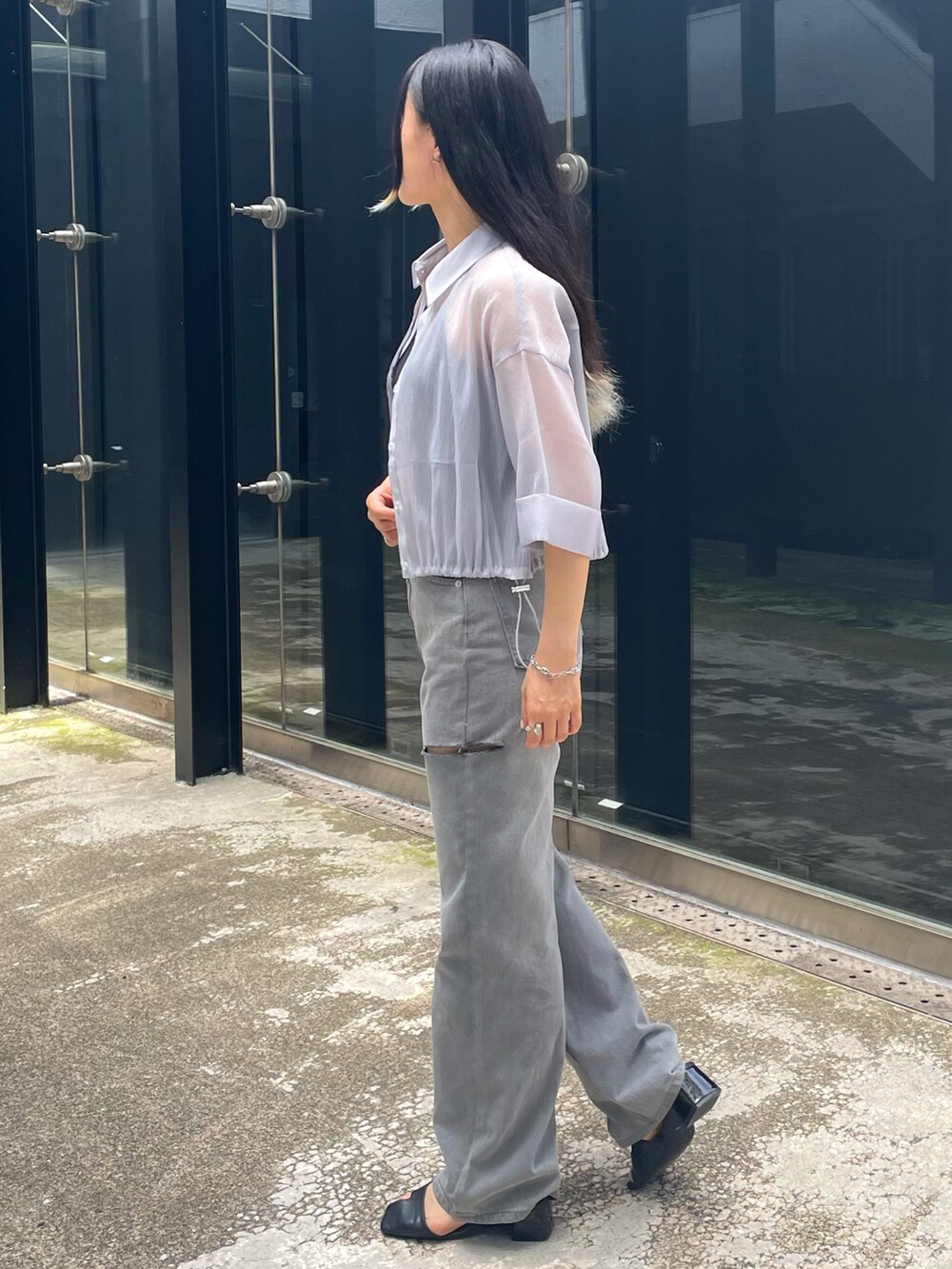 グレー系のデニムパンツ、ホワイト系のキャミソール、グレー系のシャツ/ブラウスを着用したレディースの夏コーディネートの2枚目の写真